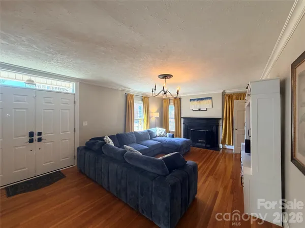 a living room with furniture fireplace and window