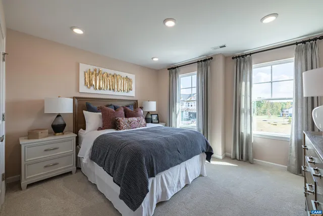 a spacious bedroom with a bed and a window