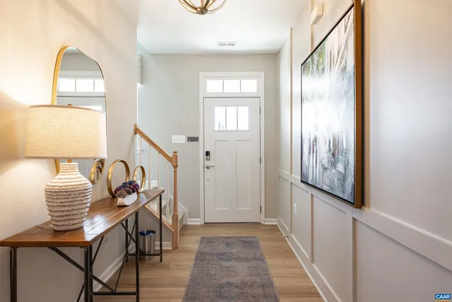 a view of an entryway with wooden floor