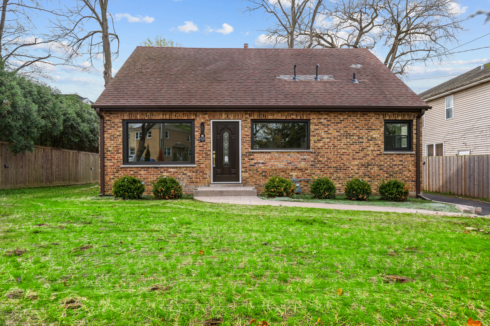 830 Deerfield Road Highland Park, IL 60035 - Photo 6 of 40 a front view of a house with a yard and garage