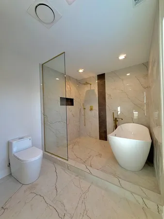 a spacious bathroom with a toilet sink and shower