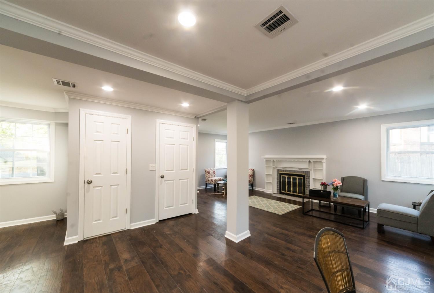 429 Chain O' Hills Road Colonia, NJ 07067 - Photo 14 of 44 a living room with furniture or wooden floor and a fireplace