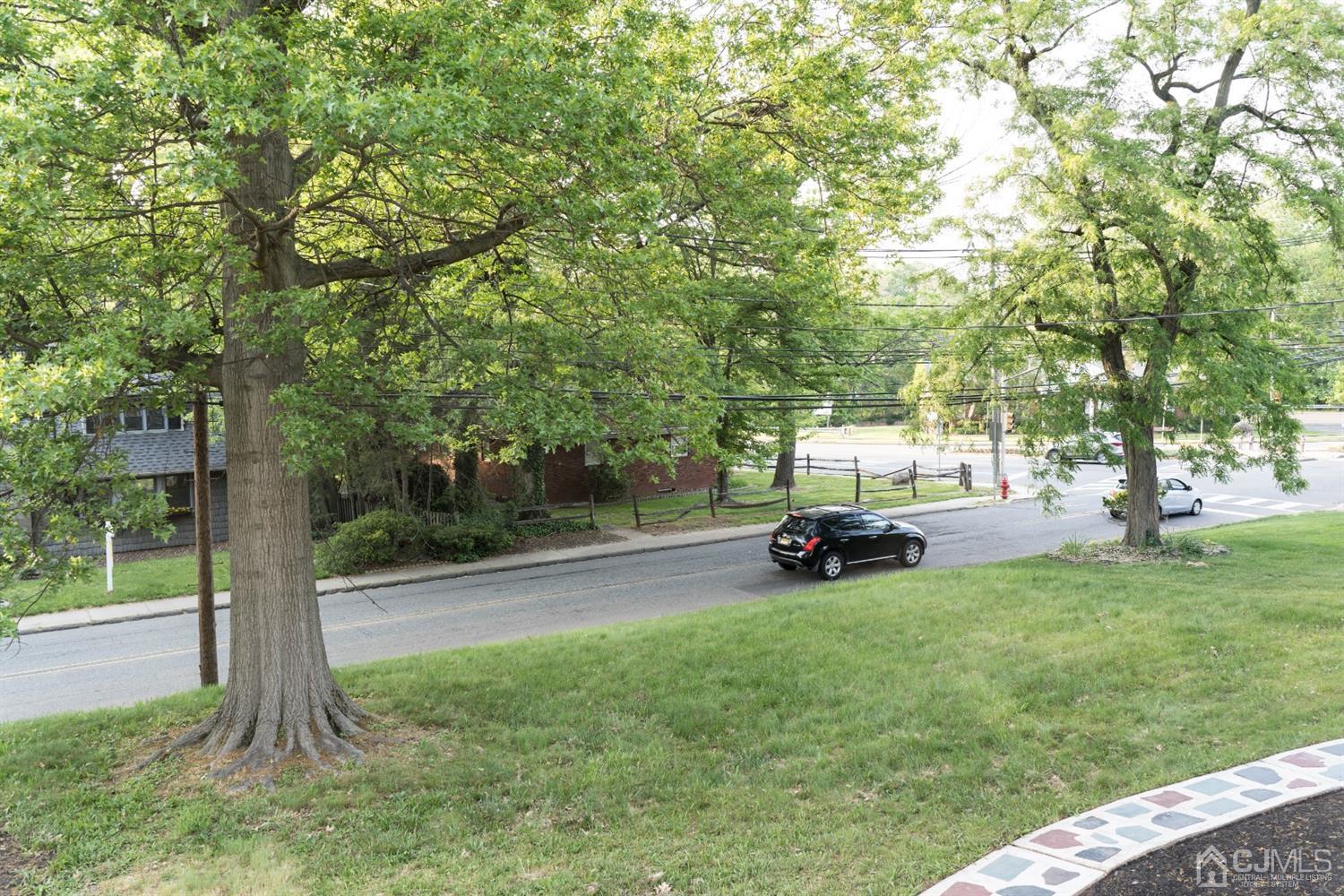 429 Chain O' Hills Road Colonia, NJ 07067 - Photo 22 of 44 a view of a park with a bench and trees