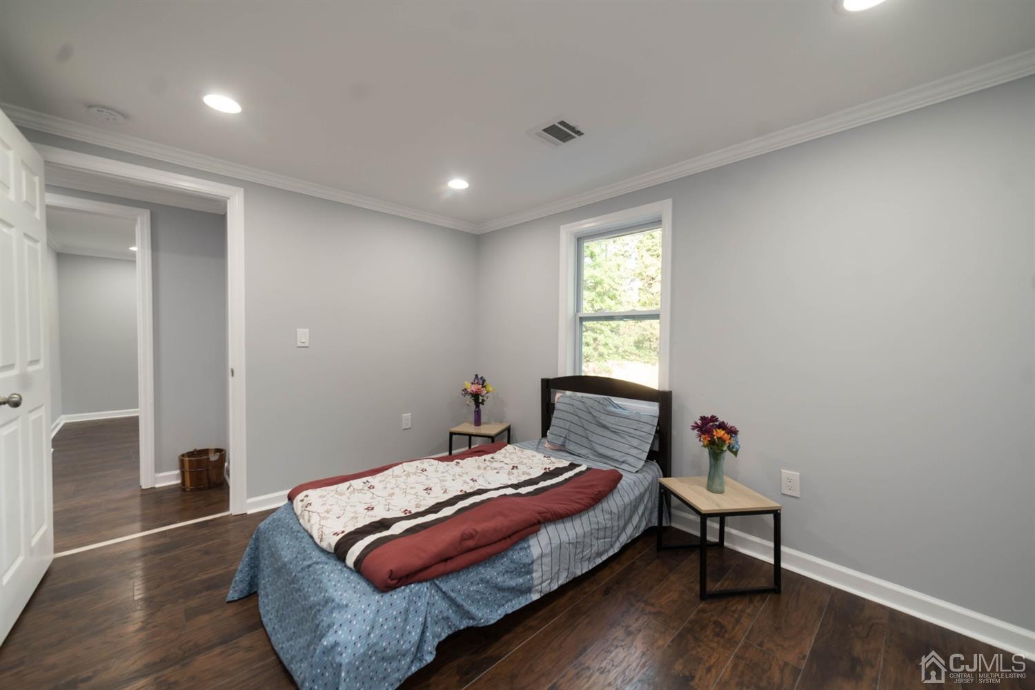 429 Chain O' Hills Road Colonia, NJ 07067 - Photo 40 of 44 a bedroom with a bed and wooden floor