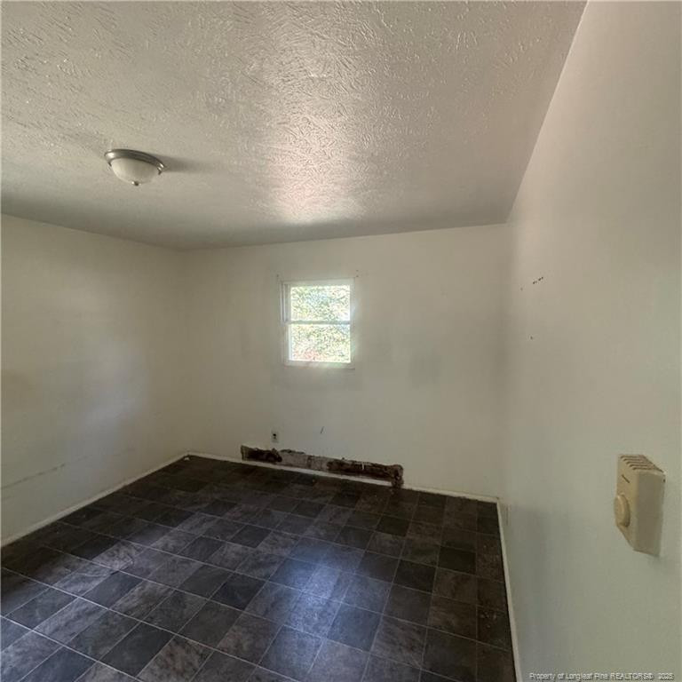 415 Brockington Road Fairmont, NC 28340 - Photo 14 of 22 an empty room with a empty space and windows