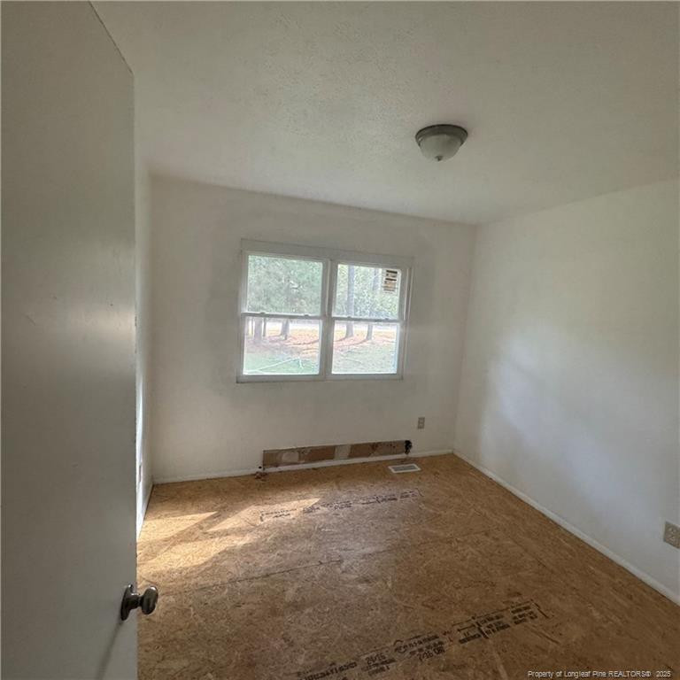 415 Brockington Road Fairmont, NC 28340 - Photo 8 of 22 an empty room with windows