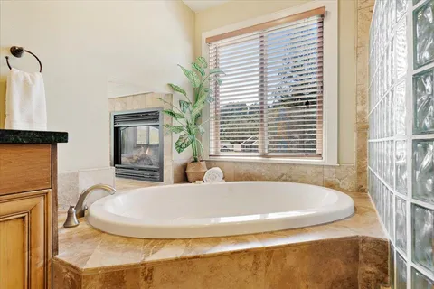a bath tub sitting in a bathroom next to a window