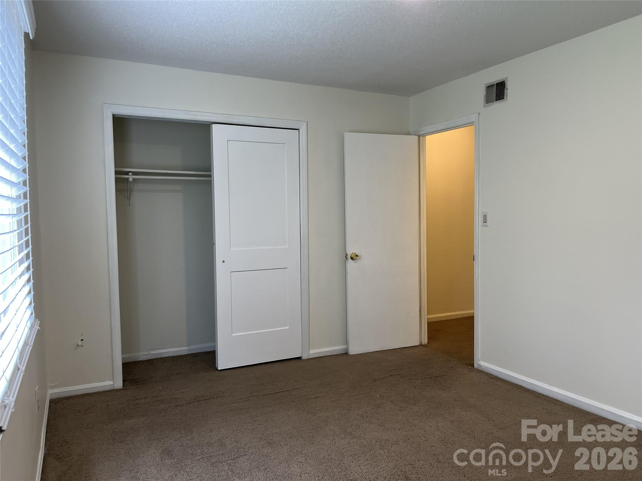 1911 Smoke Ridge Court, Unit 5 Charlotte, NC 28210 - Photo 12 of 16 a view of an empty room with window