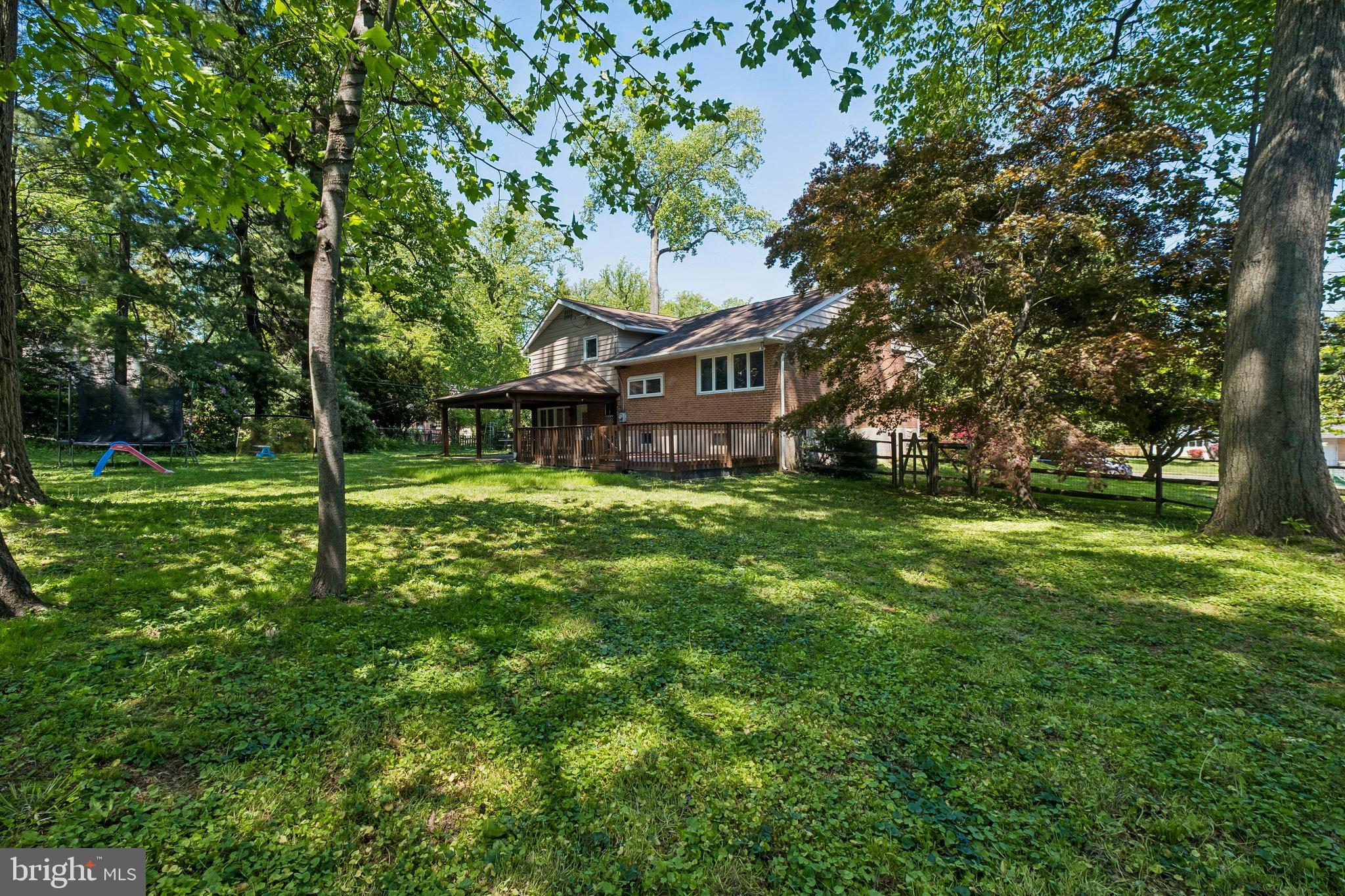 1076 Devon Road Jenkintown, PA 19046 - Photo 49 of 51 a view of a house with a big yard and large trees