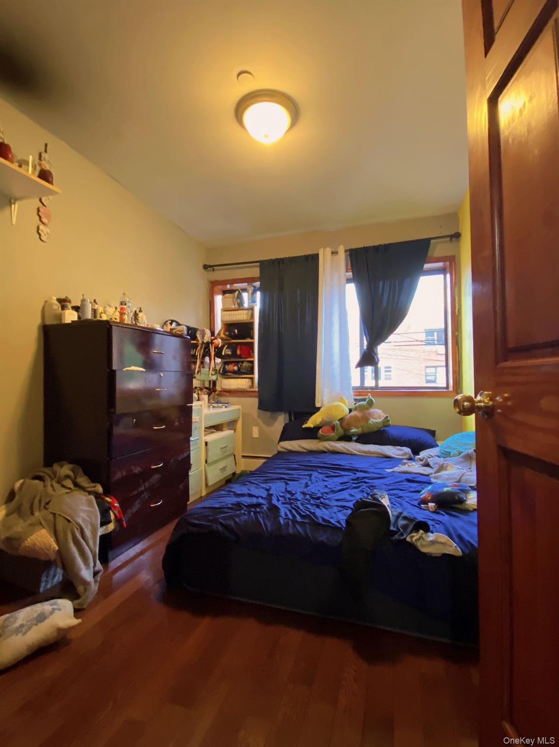 90-19 Corona Avenue Queens, NY 11373 - Photo 4 of 23 a bedroom with a bed and wooden floor