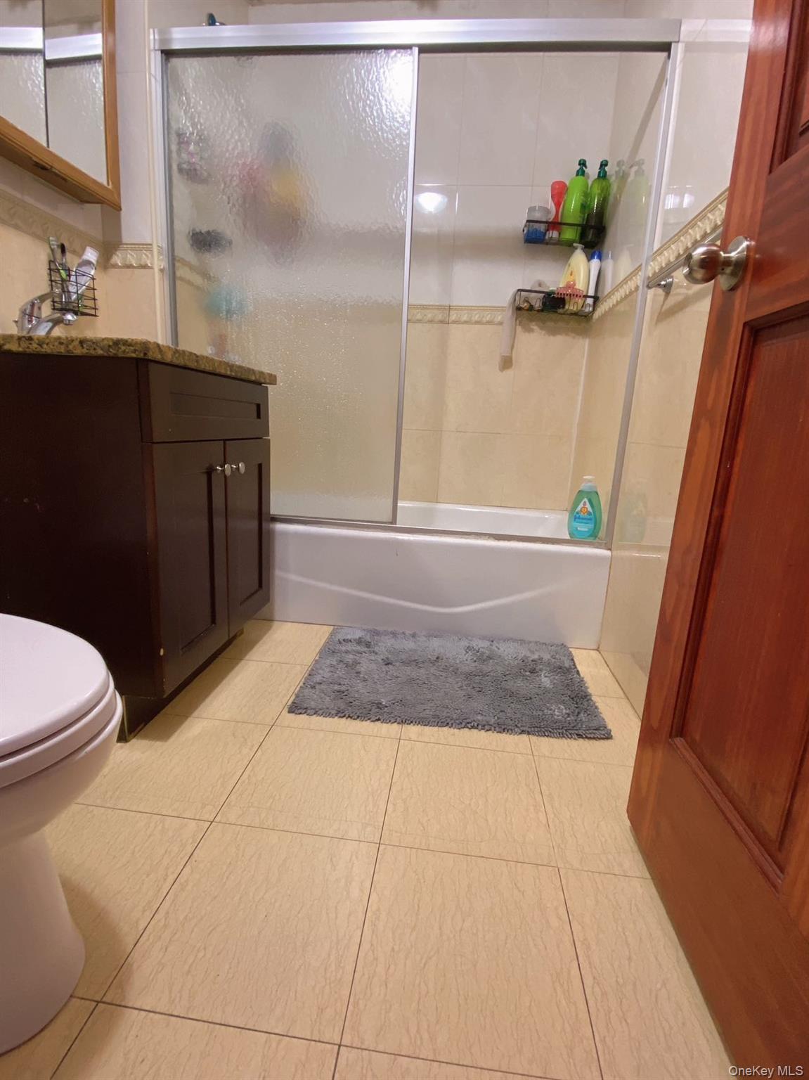 90-19 Corona Avenue Queens, NY 11373 - Photo 6 of 23 a bathroom with a granite countertop sink a toilet and a mirror