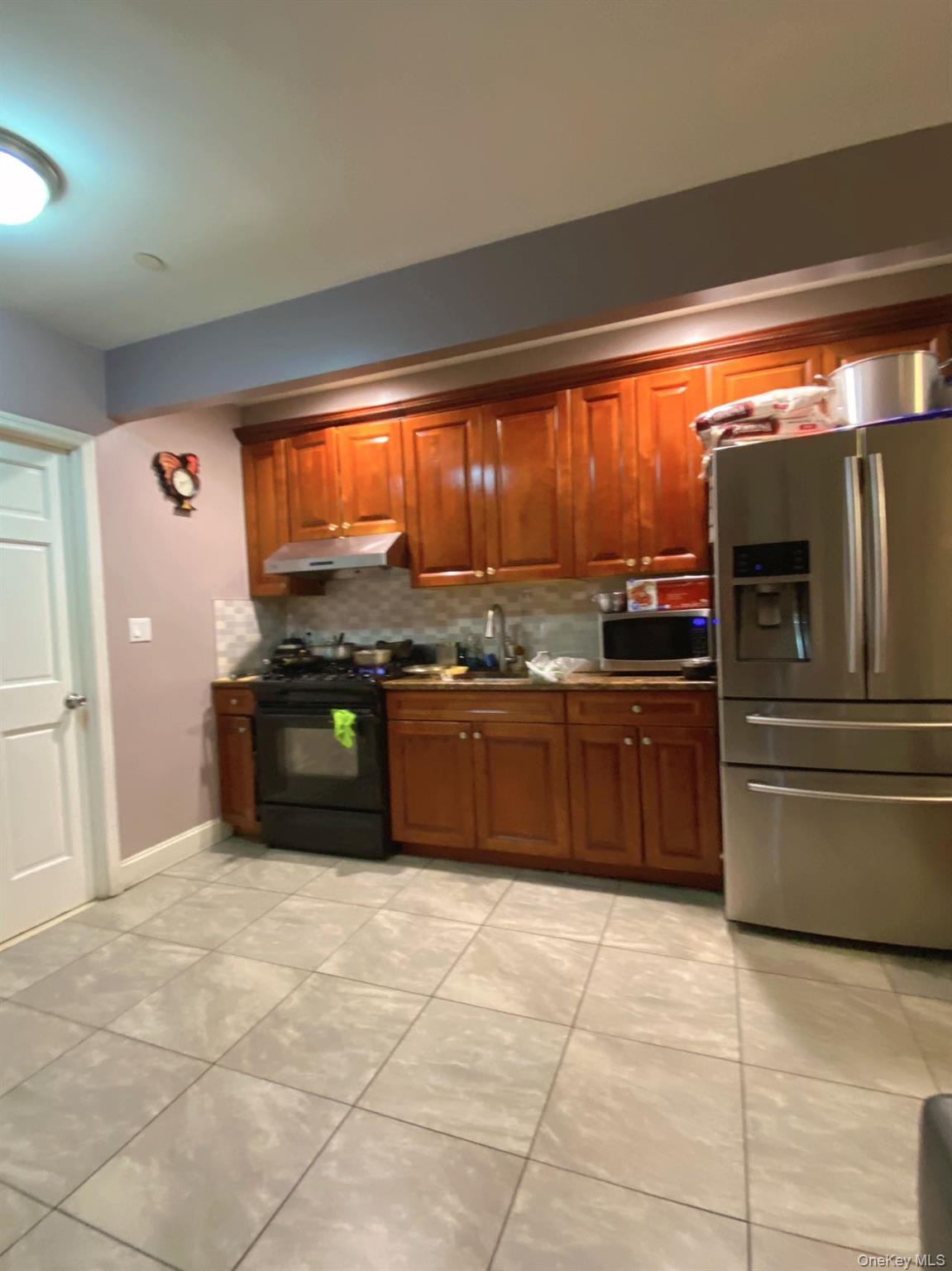 90-19 Corona Avenue Queens, NY 11373 - Photo 8 of 23 a kitchen with stainless steel appliances granite countertop a stove a sink and a refrigerator