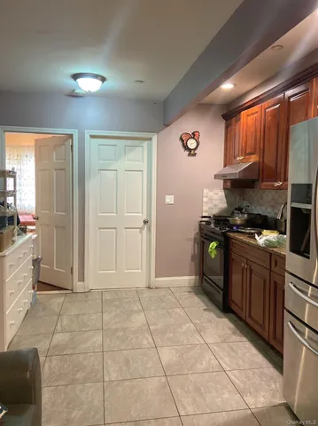 a kitchen with granite countertop a stove cabinets and a refrigerator