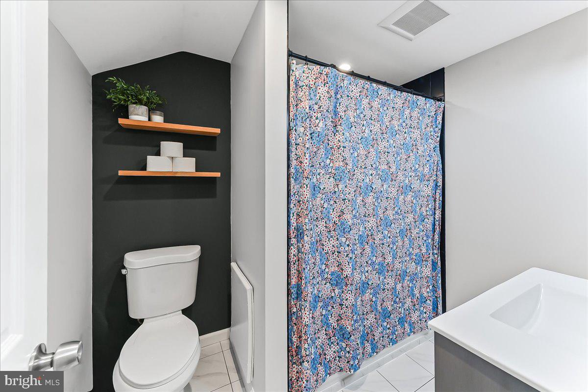 2330 Poe Road Secane, PA 19018 - Photo 26 of 33 a white toilet sitting next to a shower curtain