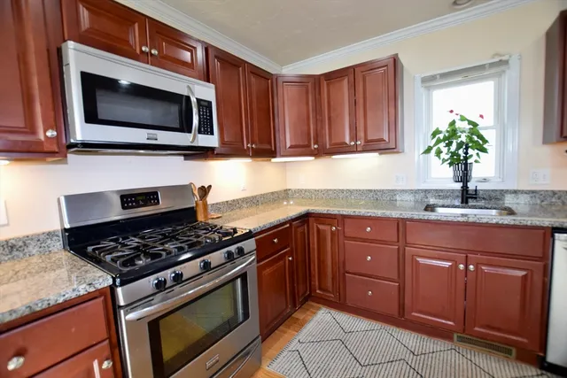 a kitchen with granite countertop a sink and a stove top oven