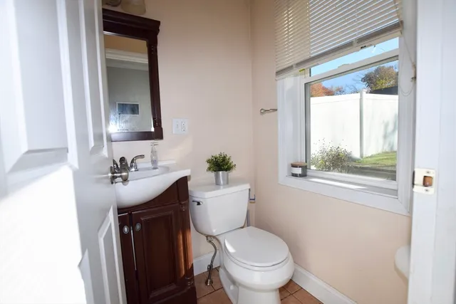 a bathroom with a granite countertop toilet a sink and a mirror