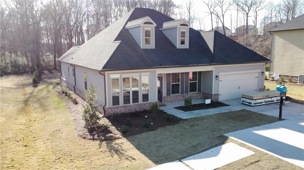 5060 Aaron Sosebee Road Cumming, GA 30040 - Photo 1 of 1 a front view of a house with garden