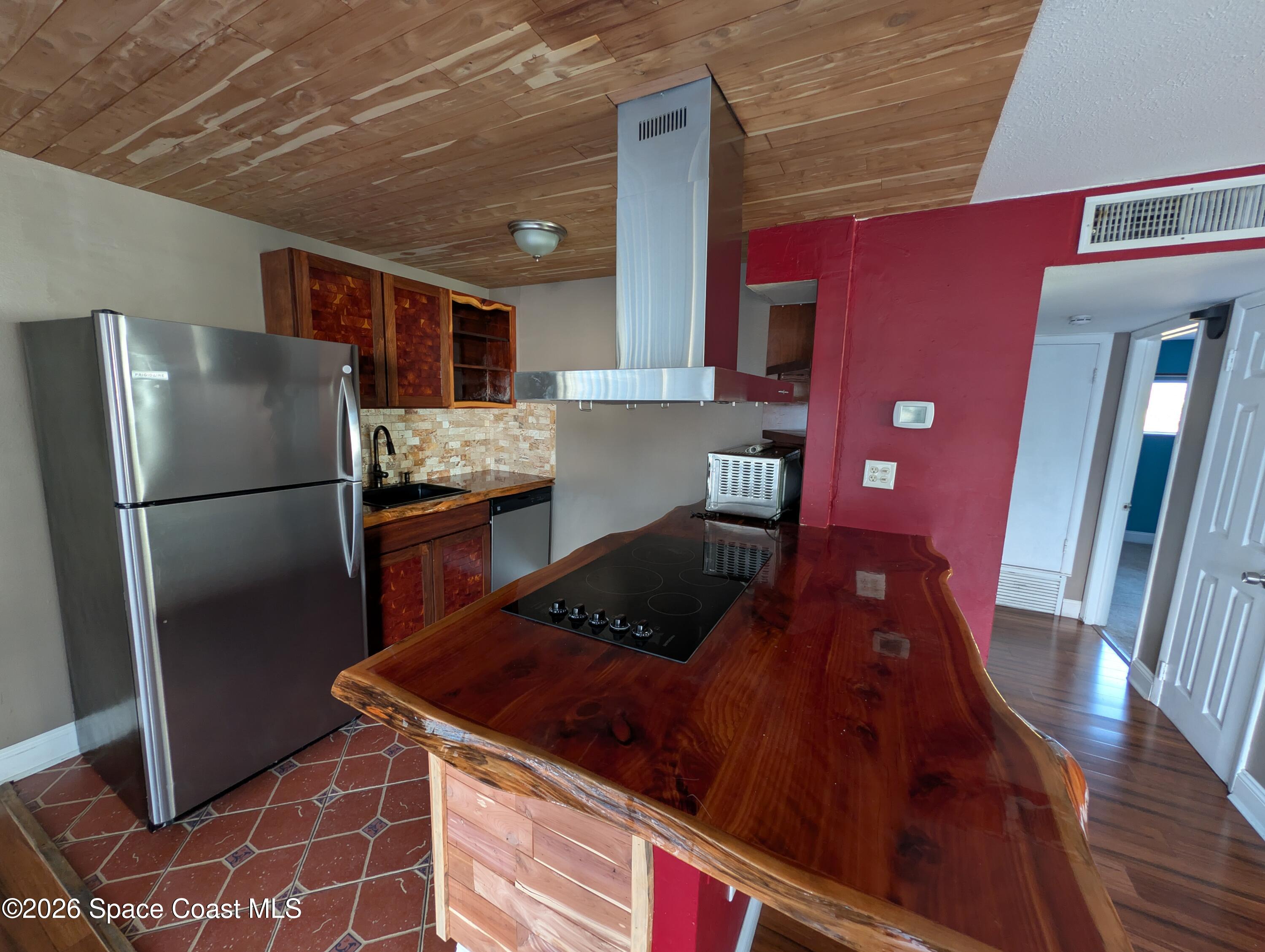 180 Minna Lane, Unit 407 Merritt Island, FL 32953 - Photo 3 of 8 a kitchen with stainless steel appliances granite countertop a refrigerator a stove and a sink
