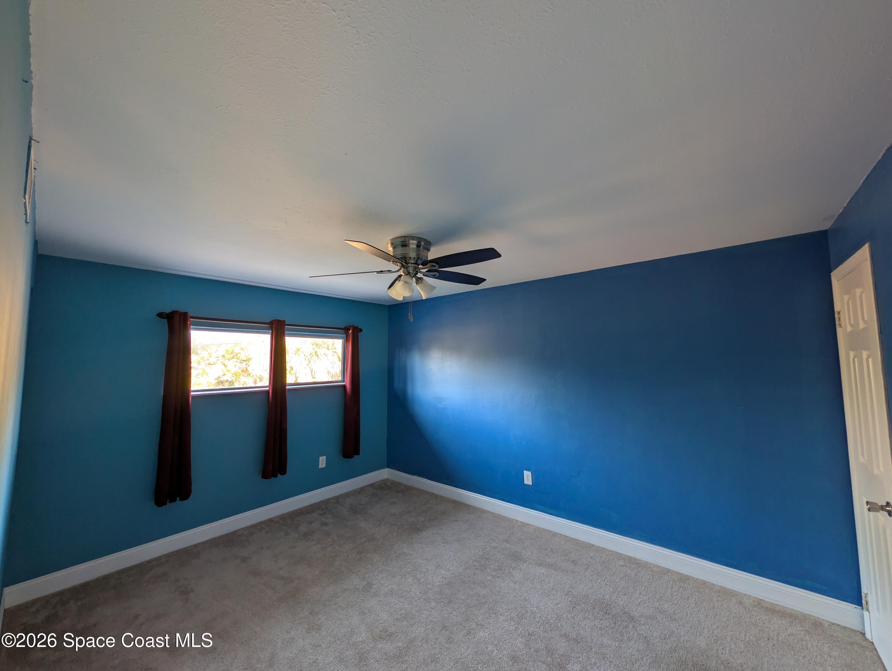 180 Minna Lane, Unit 407 Merritt Island, FL 32953 - Photo 4 of 8 an empty room with a empty space and windows