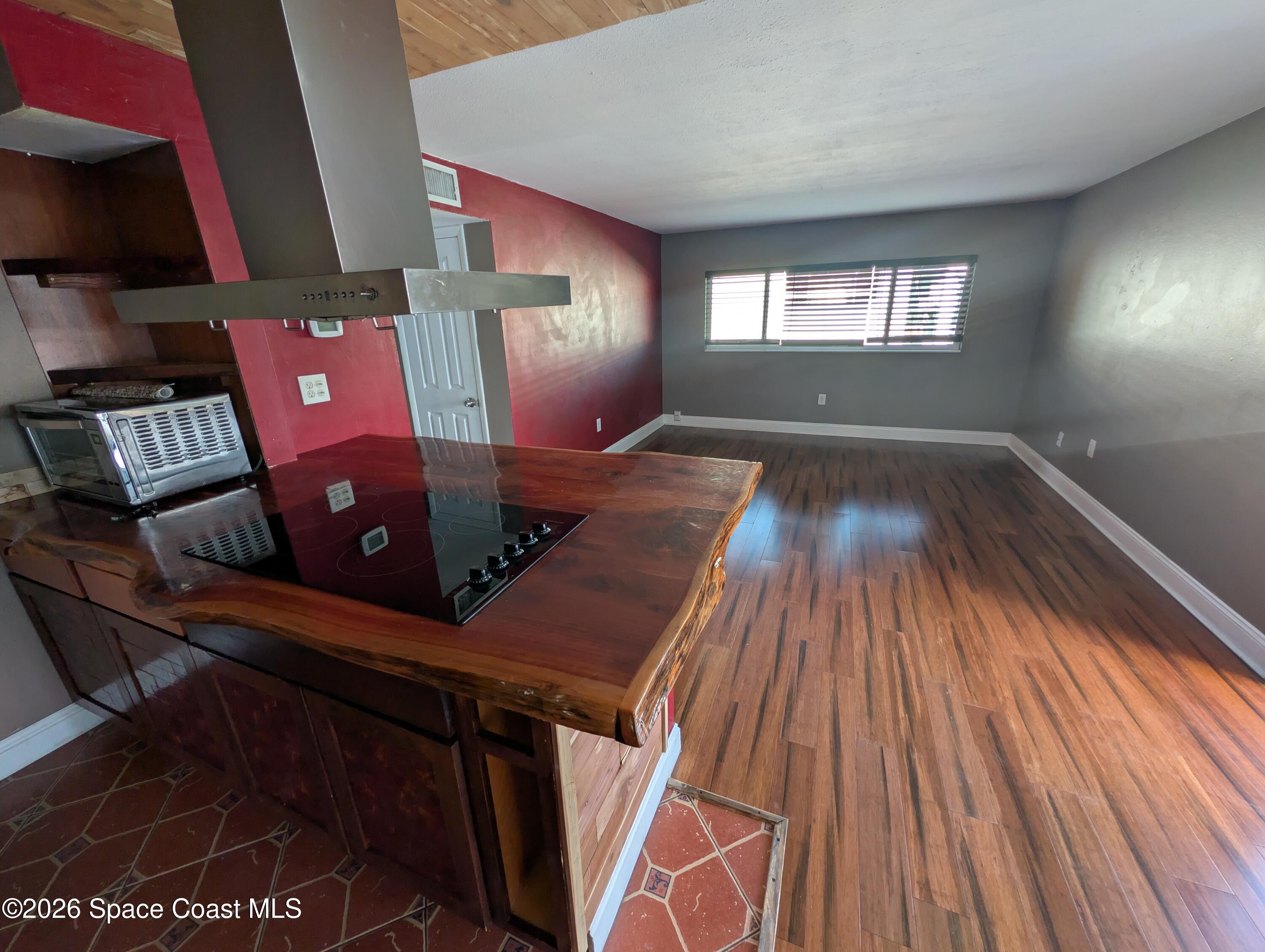 180 Minna Lane, Unit 407 Merritt Island, FL 32953 - Photo 7 of 8 a view of a living room with furniture and wooden floor