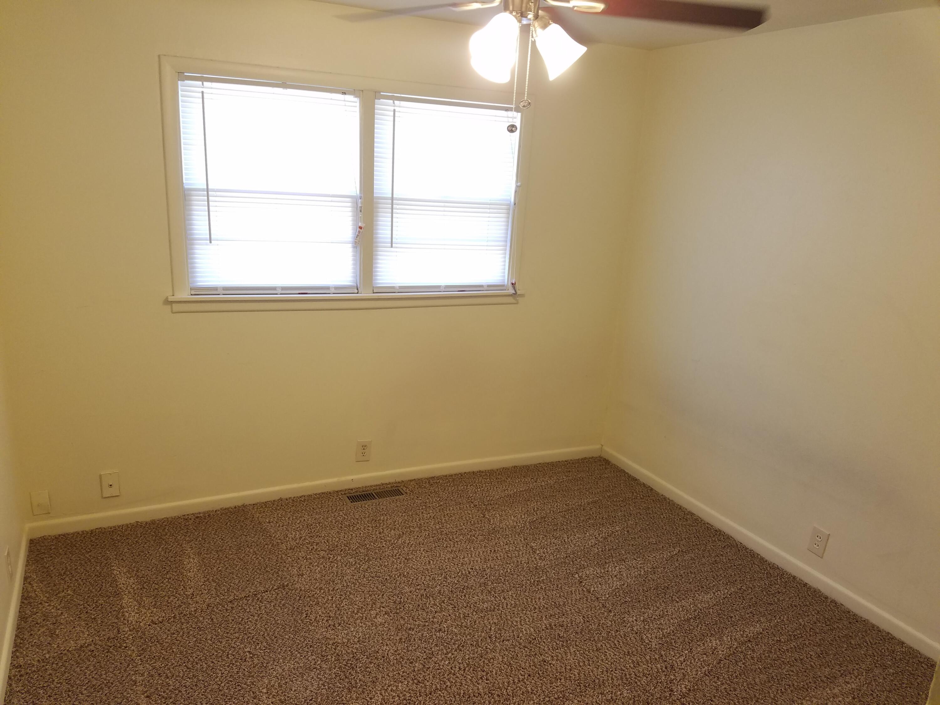 2702 22nd Street Lubbock, TX 79410 - Photo 6 of 9 an empty room with a window