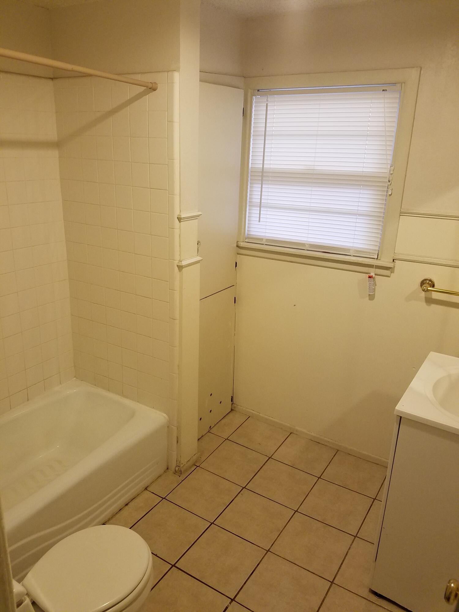 2702 22nd Street Lubbock, TX 79410 - Photo 8 of 9 a bathroom with a toilet and a shower