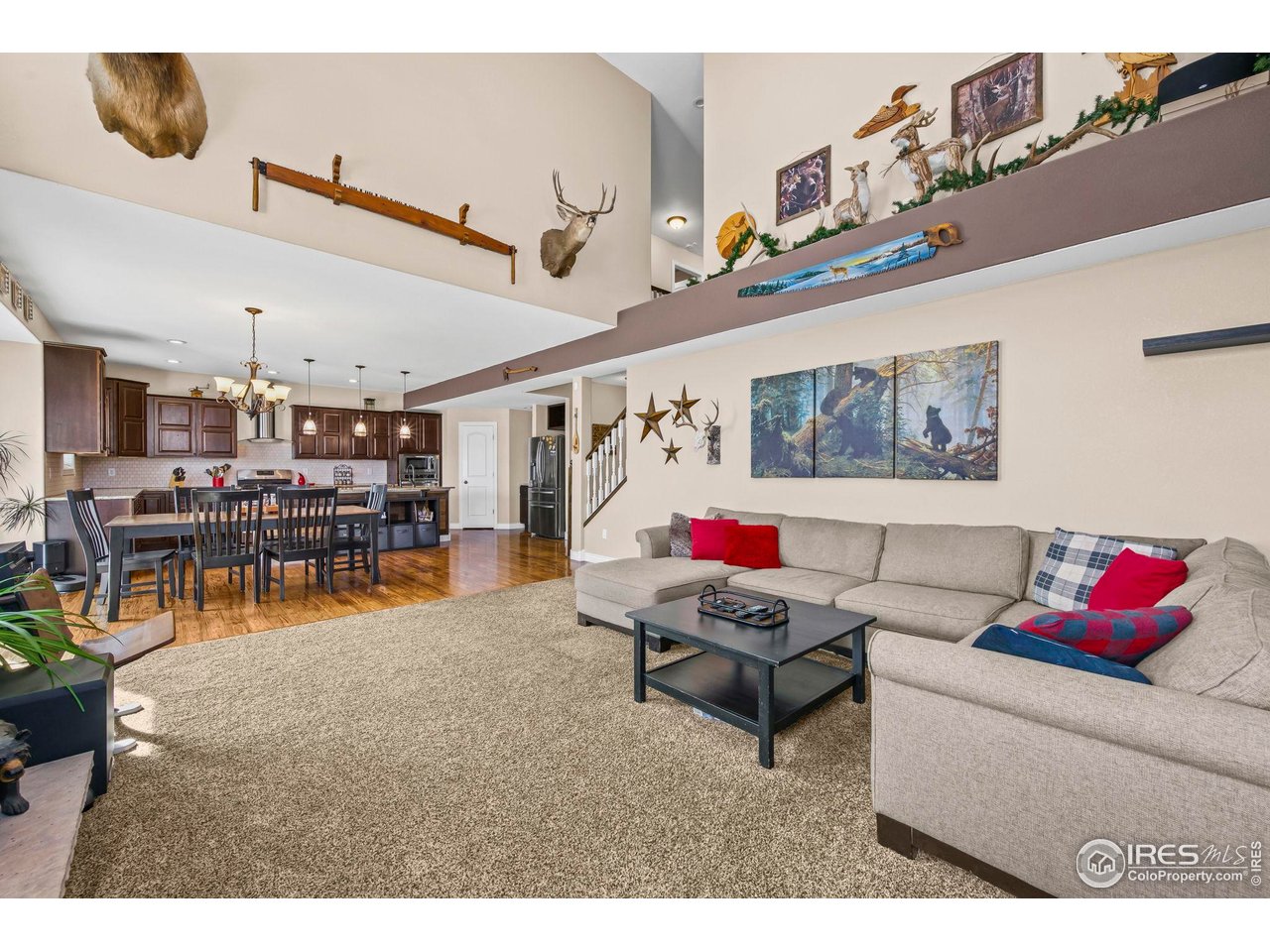 1302 Park Ridge Drive Severance, CO 80615 - Photo 18 of 35 a living room with lots of furniture and a chandelier