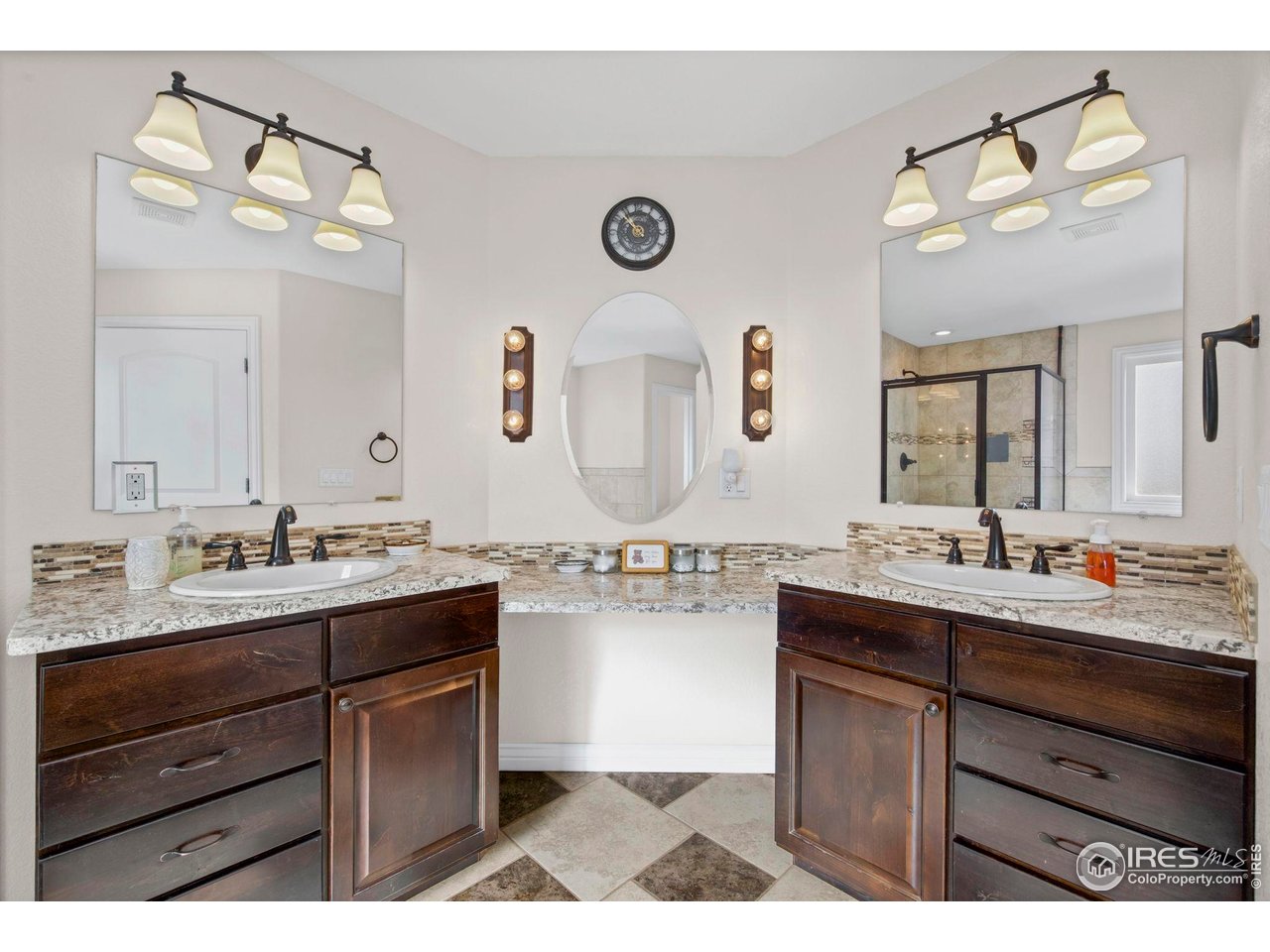 1302 Park Ridge Drive Severance, CO 80615 - Photo 22 of 35 a bathroom with a sink vanity granite and a mirror