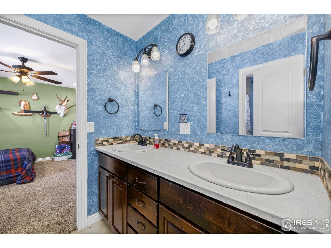 1302 Park Ridge Drive Severance, CO 80615 - Photo 25 of 35 a bathroom with a sink double vanity and a mirror