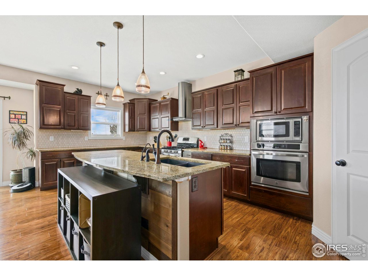 1302 Park Ridge Drive Severance, CO 80615 - Photo 10 of 35 a kitchen with stainless steel appliances granite countertop a stove top oven a sink and a refrigerator
