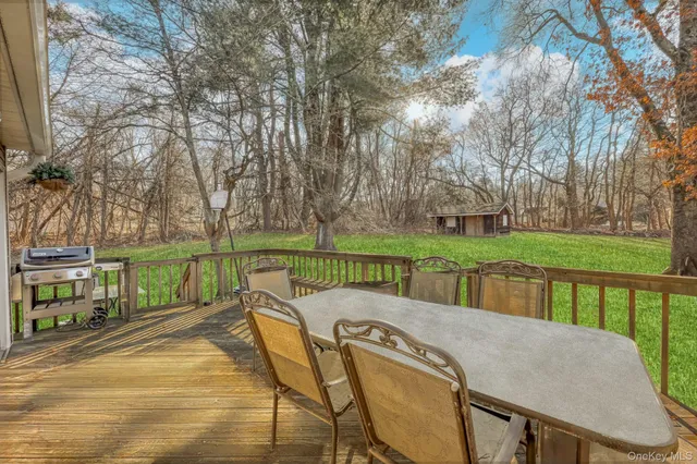 a view of a swimming pool with a patio and a yard