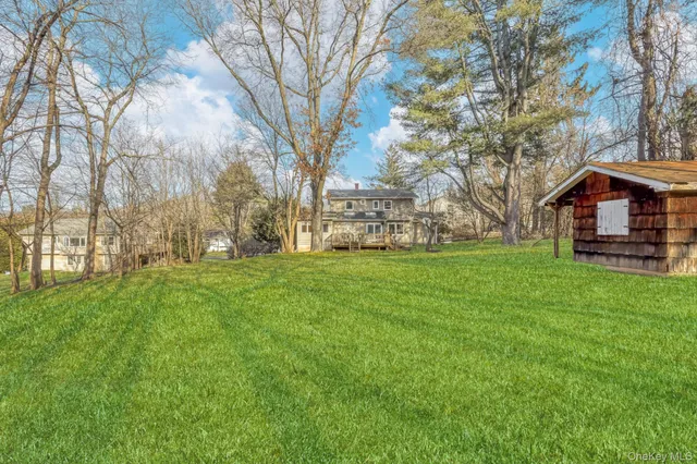 a view of a backyard with large trees