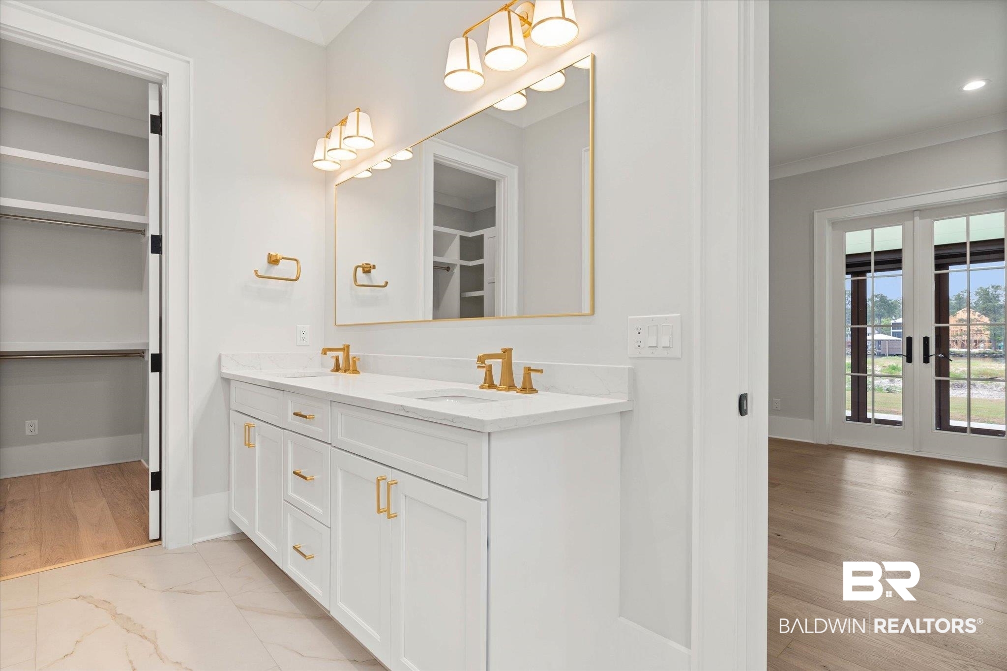 853 Inlet Circle Gulf Shores, AL 36542 - Photo 19 of 55 Full bath with crown molding, a walk in closet, a sink, double vanity, and marble finish floor