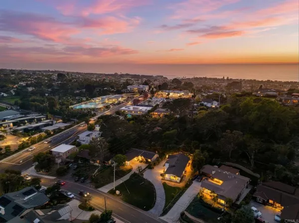 an aerial view of residential houses with outdoor space