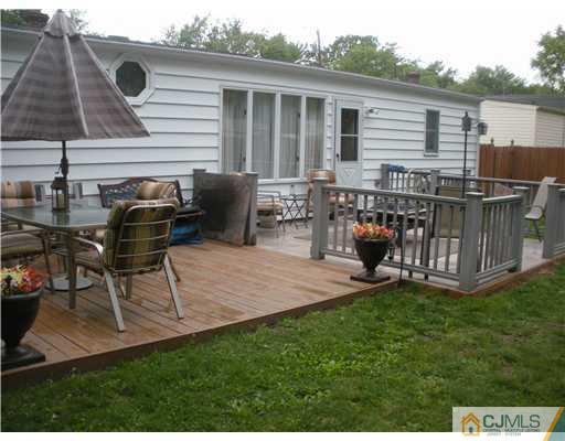 43 Cambridge Road Edison, NJ 08817 - Photo 2 of 21 a backyard of a house with table and chairs