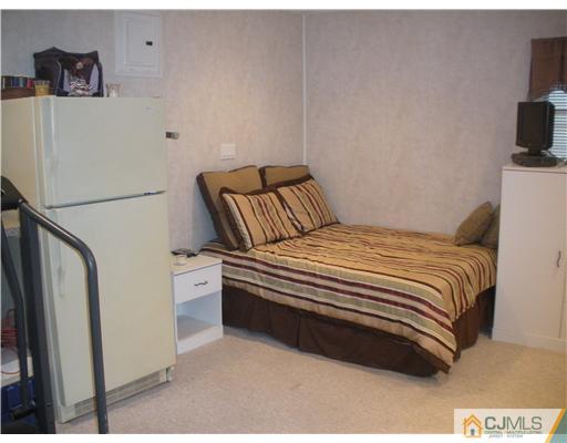 43 Cambridge Road Edison, NJ 08817 - Photo 19 of 21 a bedroom with a bed and a flat screen tv