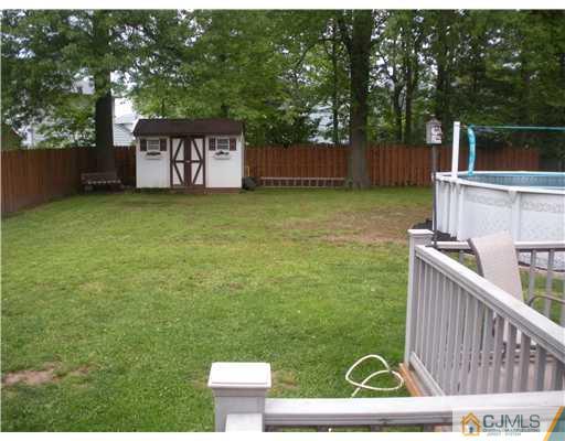 43 Cambridge Road Edison, NJ 08817 - Photo 3 of 21 a view of a chairs and table in the backyard