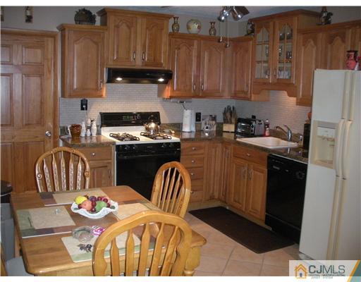 43 Cambridge Road Edison, NJ 08817 - Photo 4 of 21 a kitchen with stainless steel appliances kitchen island granite countertop a refrigerator a stove a sink and dishwasher with wooden floor