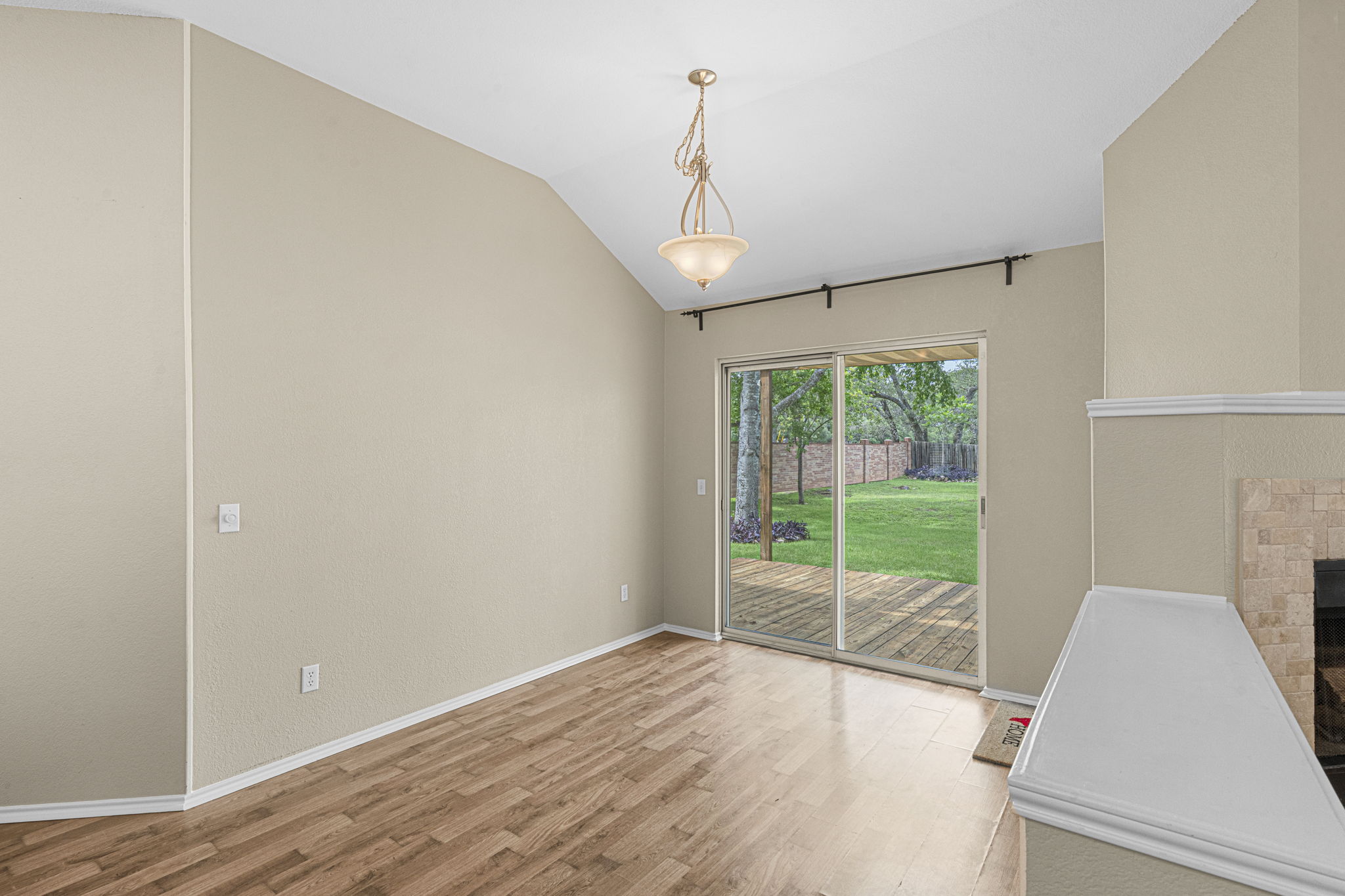 7172 Ridge Oak Road Austin, TX 78749 - Photo 25 of 40 Natural light floods this inviting living space, connecting seamlessly to a private outdoor deck and verdant yard.