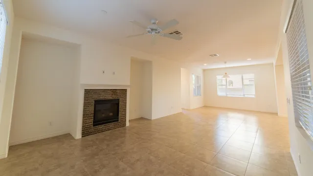 a view of empty room with a fireplace