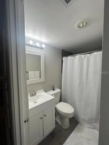 a bathroom with a toilet a sink and shower