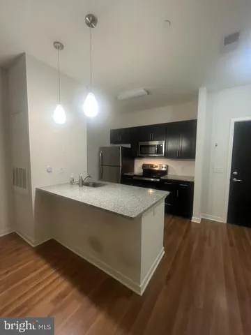 a kitchen with a refrigerator stove and microwave