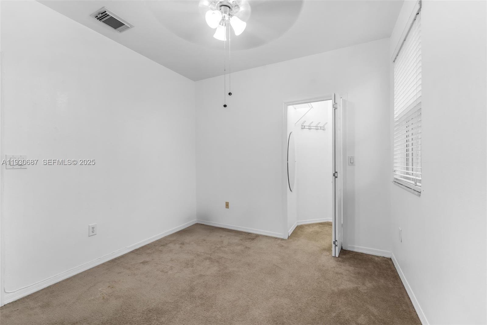 13820 Southwest 275th Street Homestead, FL 33032 - Photo 15 of 36 an empty room with a chandelier fan