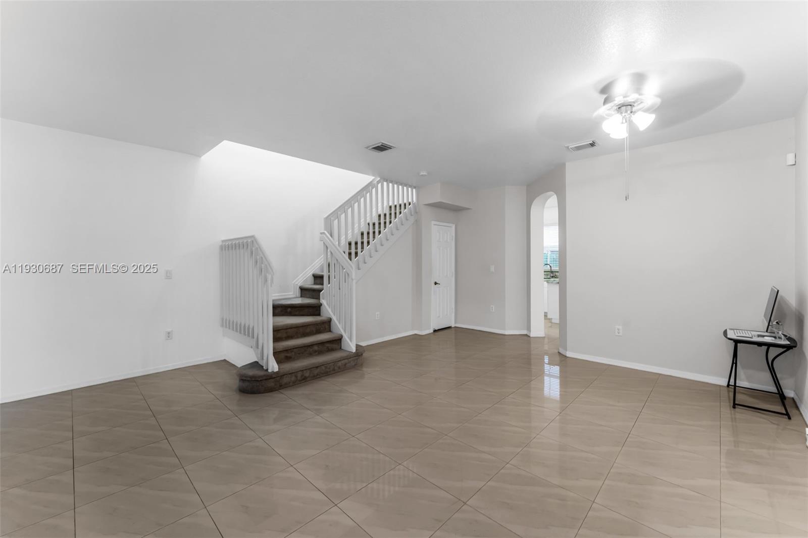 13820 Southwest 275th Street Homestead, FL 33032 - Photo 3 of 36 a view of an empty room with a chandelier fan