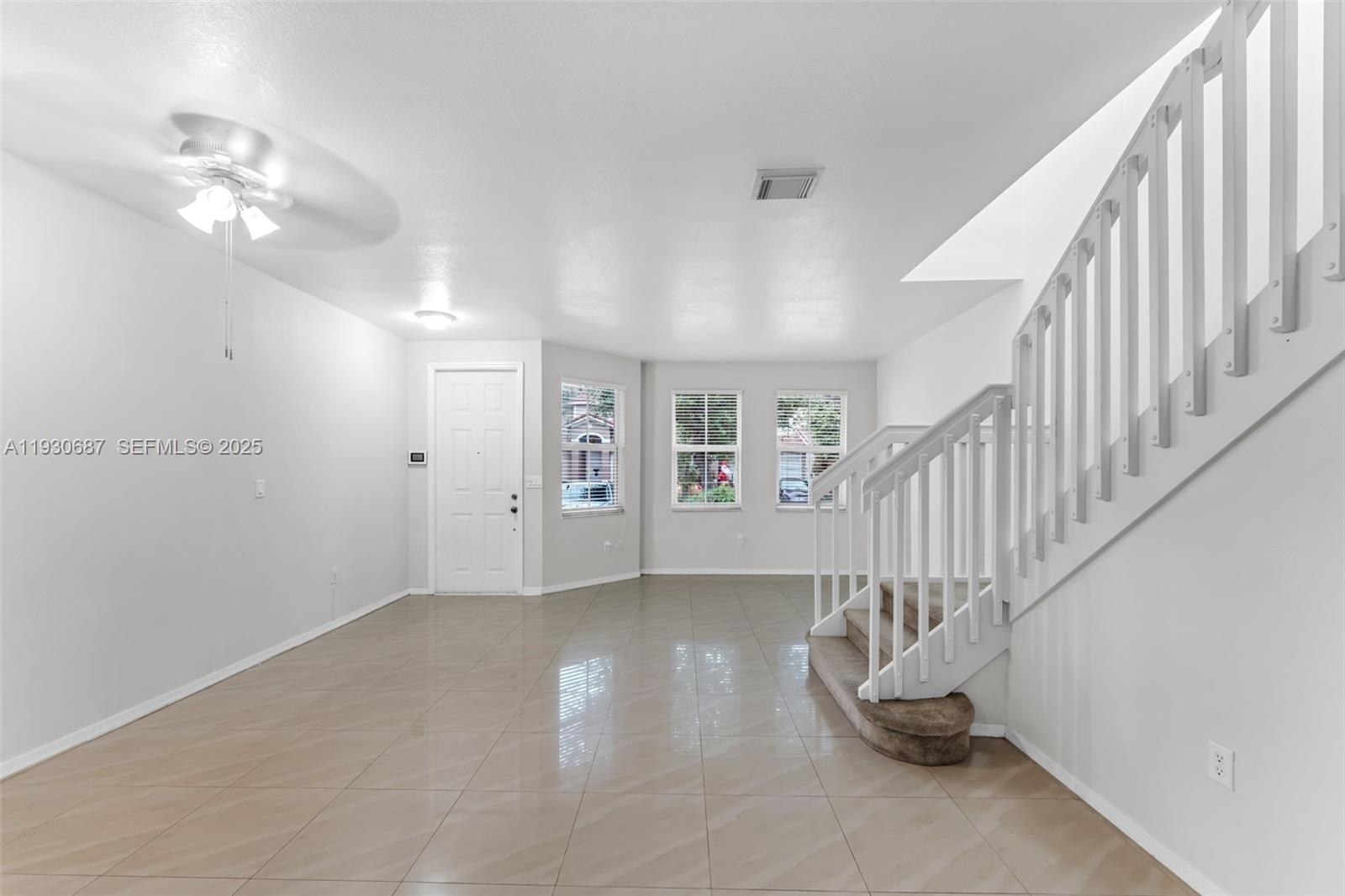 13820 Southwest 275th Street Homestead, FL 33032 - Photo 5 of 36 a view of an empty room with staircase