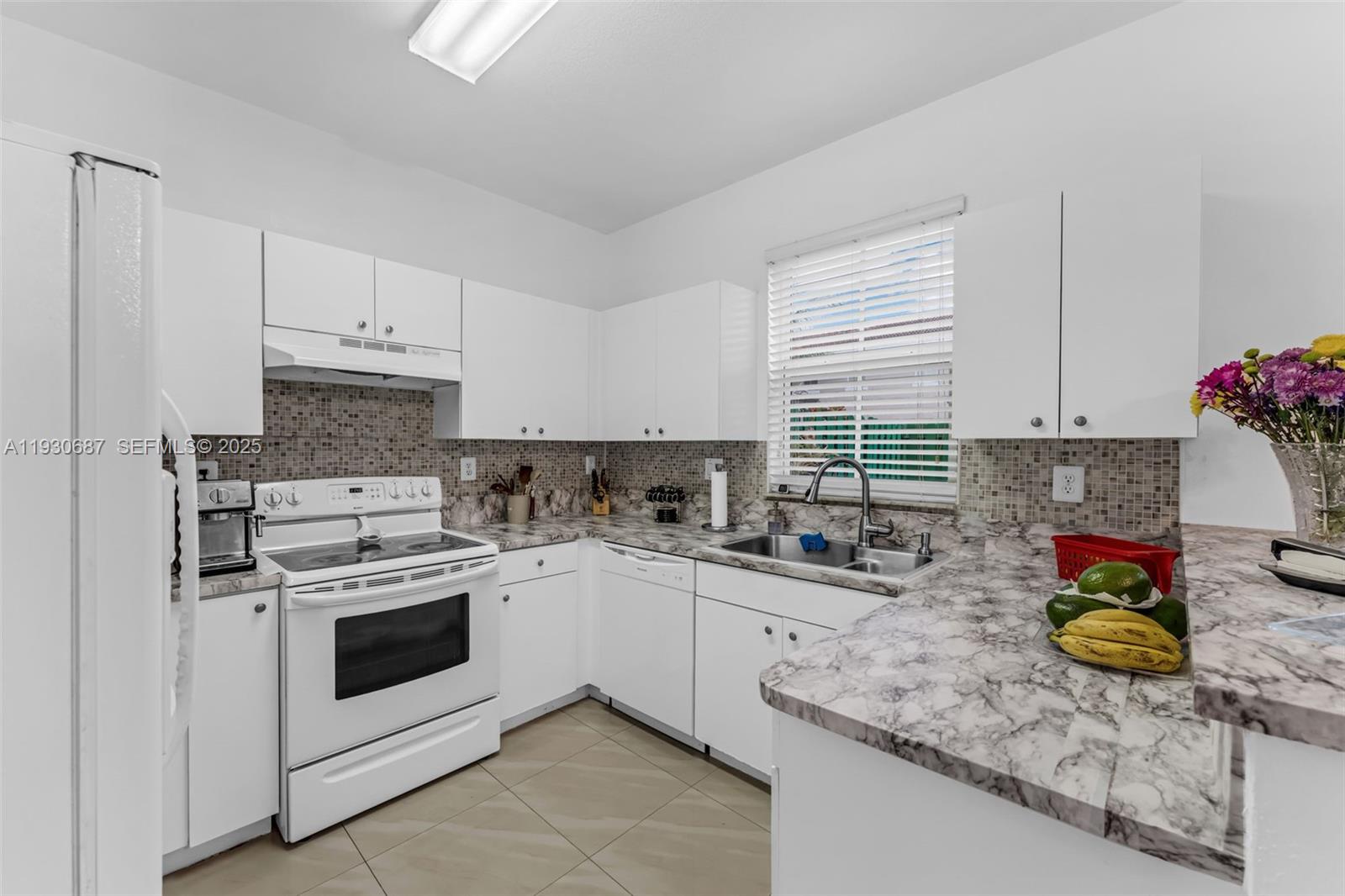 13820 Southwest 275th Street Homestead, FL 33032 - Photo 8 of 36 a kitchen with a sink a stove and cabinets
