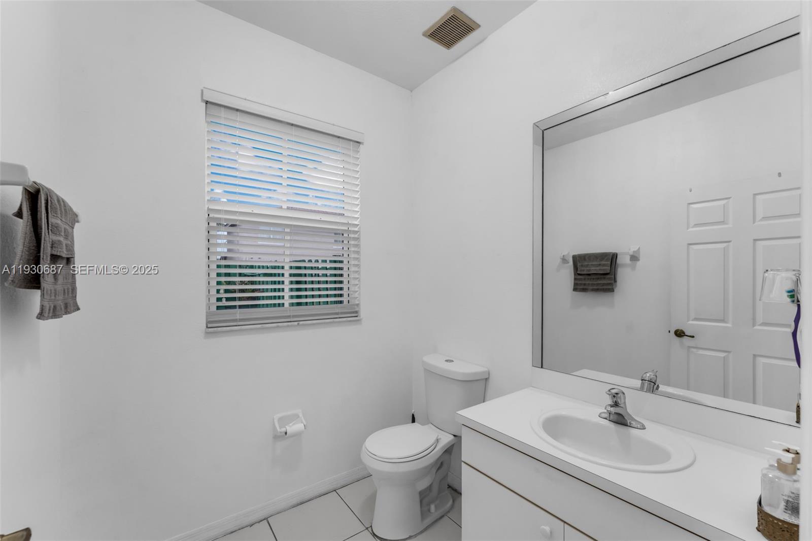 13820 Southwest 275th Street Homestead, FL 33032 - Photo 10 of 36 a bathroom with a sink toilet and a mirror