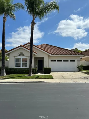 a front view of a house with a garden and entryway