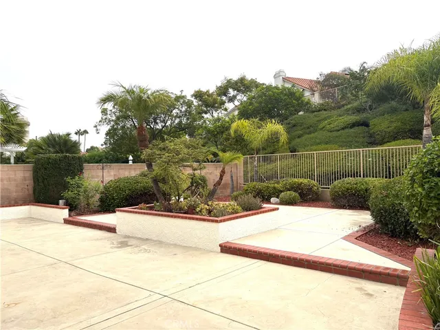 a view of a park with plants and a bench