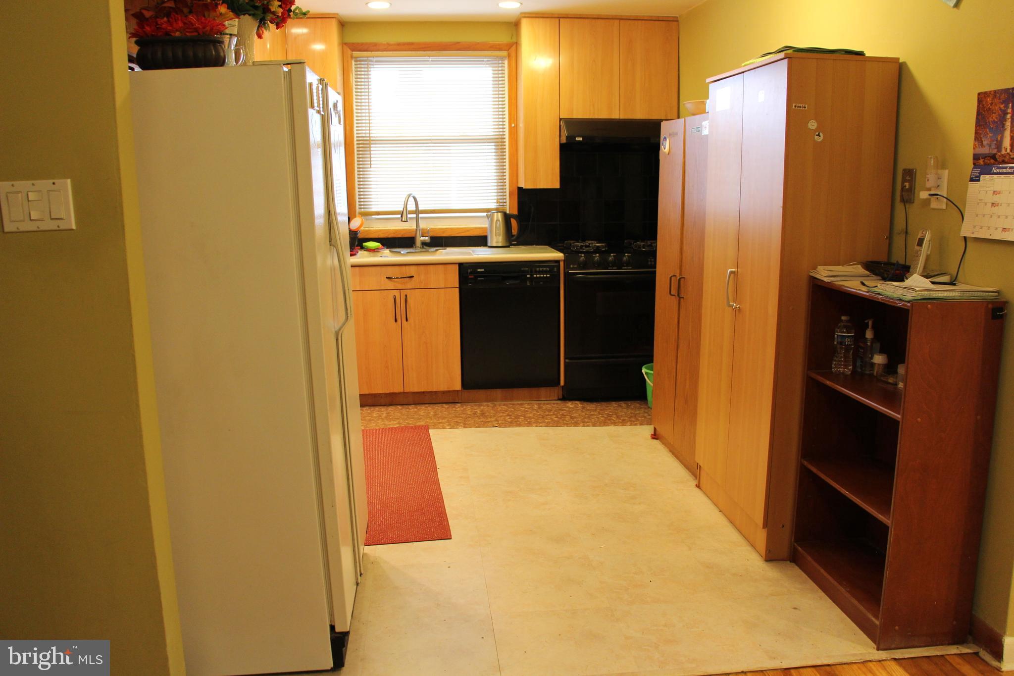 635 Colebrook Road Philadelphia, PA 19115 - Photo 12 of 31 a kitchen with a refrigerator and a stove